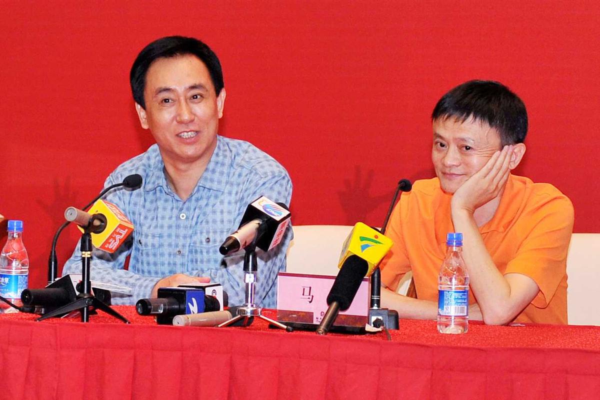 Chairman of Evergrande Group Xu Jiayin (L) and founder and chairman of Alibaba Group Jack Ma in Guangzhou, China, on June 5, 2014. Alibaba had just agreed to buy 50 percent of the Guangzhou Evergrande soccer team from Xu Jiayin. Did Jack Ma also buy some of Evergrande's debt? (ChinaFotoPress via Getty Images)