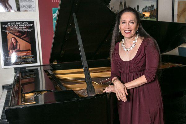 Julie Jordan, founder and artistic director of New York Concerti Sinfonietta by one of her Steinway pianos in her Upper West Side studio in Manhattan on April 23, 2015. (Benjamin Chasteen/Epoch Times)