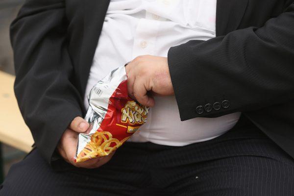 A man eats junk food on May 23, 2013 in Leipzig, Germany. (Sean Gallup/Getty Images)