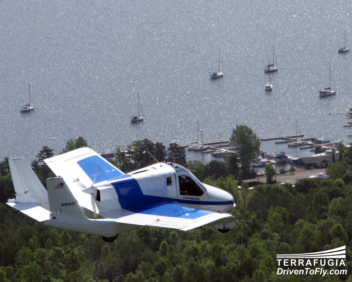 Terrafugia's Transition flying over sailboats. (Terrafugia)