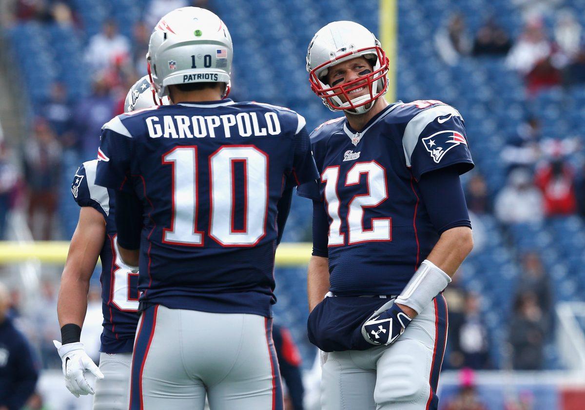 Jimmy Garoppolo and Tom Brady. (Photo by Jim Rogash/Getty Images)
