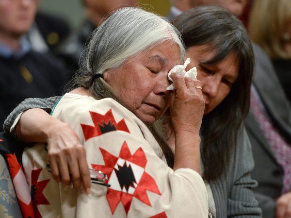 A woman is comforted in the audience during the closing ceremony of the Indian Residential Schools Truth and Reconciliation Commission, at Rideau Hall in Ottawa on June 3, 2015. (The Canadian Press/Sean Kilpatrick)