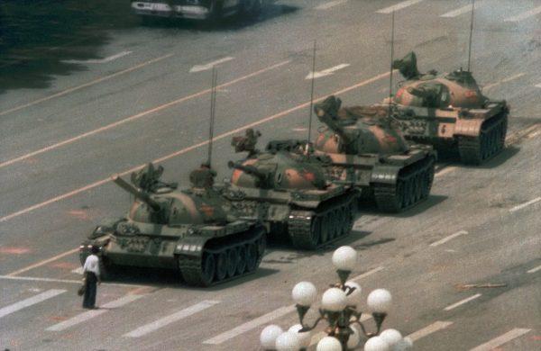 A Chinese man, now known as "Tank Man," stands alone to block a line of tanks heading east on Beijing’s Avenue of Eternal Peace on June 5, 1989, during the Tiananmen Square Massacre. (Jeff Widener/AP Photo)