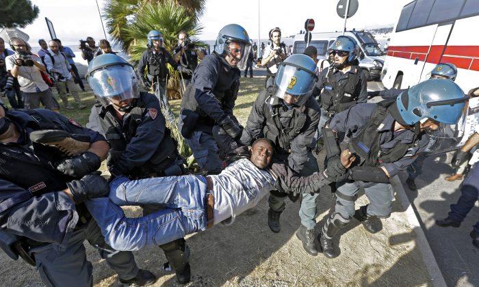 Police in Helmets Drag Migrants From French-Italian Border