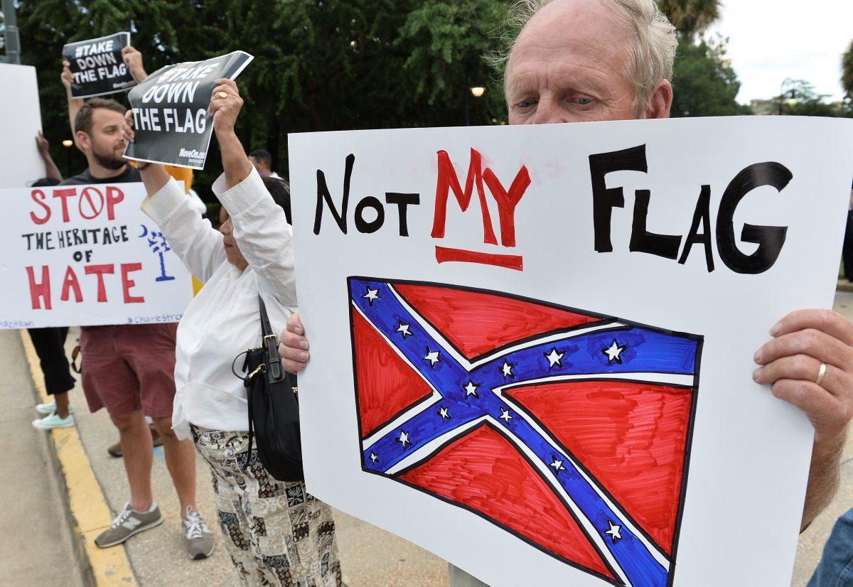 A man holds a sign up during a protest rally against the Confederate flag in Columbia, South Carolina, on June 20, 2015. (Mladen Antonov/AFP/Getty Images)