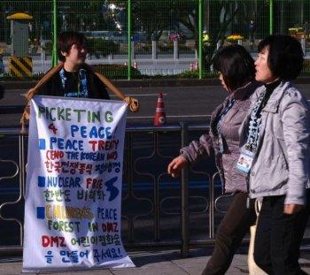 Young Protester Detained at Tiananmen Square for Promoting Peace in Korea (Video)