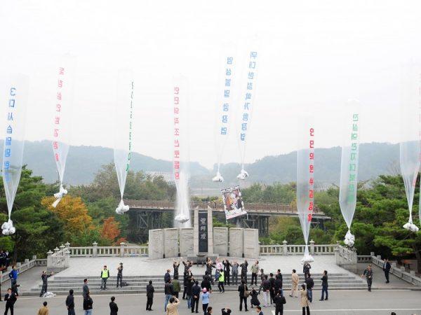 Anti-North Korea activists launch balloons, carrying anti-regime leaflets and a photo of Hwang Jang-Yop, the highest-ranking defector ever to flee to the South, in Paju near a heavily fortified border on Oct. 10, 2011. (Park Ji-Hwan/AFP/Getty Images)