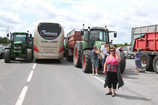 French farmers block the road leading to the famed Mont Saint Michel, France, on July 23, 2015, hoping to get more government help to counteract cheap imports and pressure from grocery chains. (David Vincent/AP Photo)