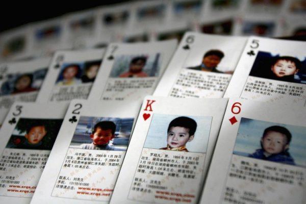 The "missing children playing cards" are displayed by Shen Hao, the founder of a missing person website, the www.xrqs.com, on March 31, 2007 in Beijing, China. The cards show photographs and informations about 27 missing children. Shen Hao  hand them to public security departments, civil affairs bureaus ,and residents in areas notorious for child trafficking. (China Photos/Getty Images)