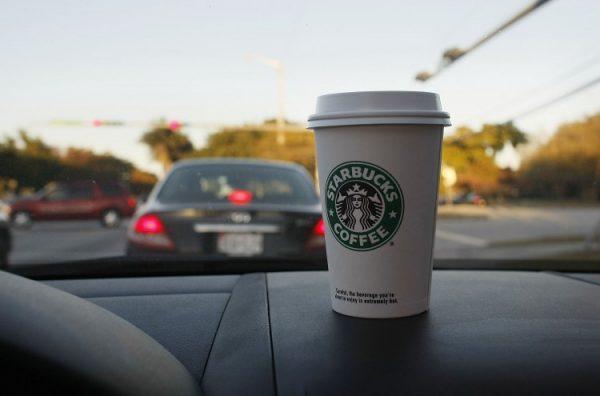 A Starbucks coffee cup is shown on the dashboard of a car in Miami, Fla. in this undated photo. (Joe Raedle/Getty Images)