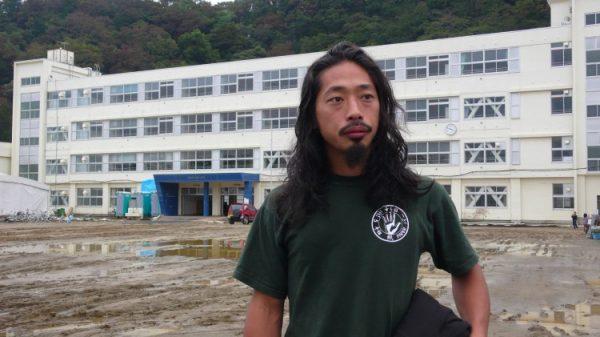 Chun Kawara, from Kyoto, stands outside Ishinomaki Minato Elementary School, which as an emergency shelter for Japanese tsunami victims. Kawara spent six months fixing bicycles for survivors, becoming something of a community hero. (Cindy Drukier/The Epoch Times)