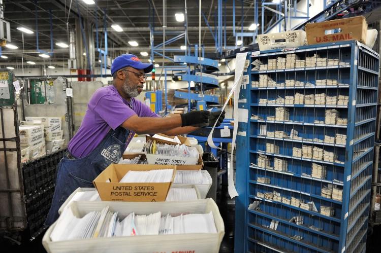 The U.S. Postal Service works hard to deliver mail throughout the country six days a week, but years of falling revenues and growing financial problems have prompted many to recommend better ways to allocate postal resources. (Brian Kersey/Getty Images)