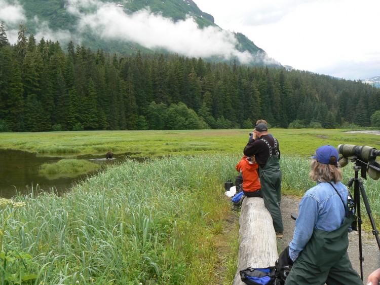 Visitors look at wildlife through binoculars in the Tongass National Forest on July 13, 2007. (Photo courtesy of the US Forest Service; Tongass National Forest photo library)