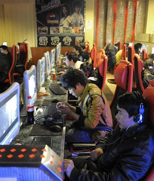 Young men use computers at an internet cafe in Beijing. The United States could leverage trade and technology to help counter censorship and surveillance in China enabled through that same trade and technology, said a panel hosted by the Congressional-Executive Commission on China. (Liu Jin/AFP/Getty Images)