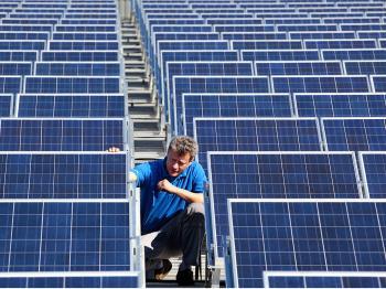 A technician checks the panels of a solar power system. Green energy technicians will be in demand as alternative energy replaces fossil fuels. (Michael Urban/AFP/Getty Images)