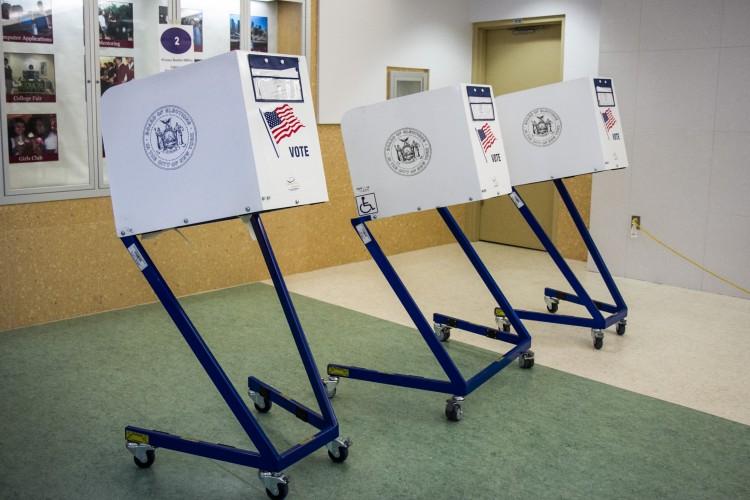 Empty voting booths at a public school in the Financial District in New York on Sept. 13, 2016. (Benjamin Chasteen/The Epoch Times)