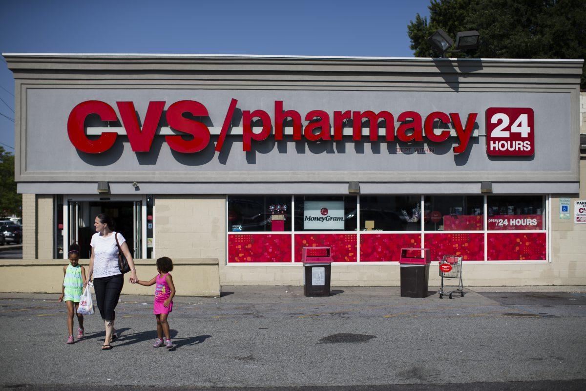 Shoppers leave a CVS pharmacy in a file photo. (John Minchillo/AP Photo)