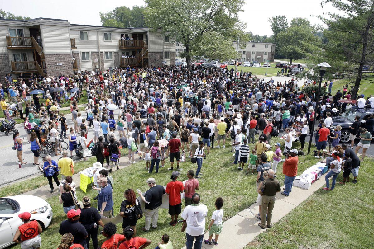 Several hundred people gather for a remembrance for Michael Brown in Ferguson, Mo., on Aug. 9, 2015. (Jeff Roberson/AP Photo)