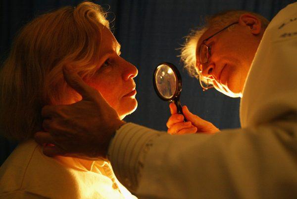 A doctor from the American Academy of Dermatology checks Christine Trerotoli for signs of skin cancer (Spencer Platt/Getty Images)