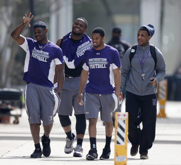 Unidentified Northwestern football players in Evanston, Ill. on April 25, 2014. (Charles Rex Arbogast/File photo via AP)