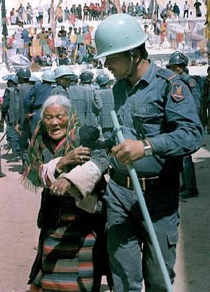 An injured Tibetan woman is taken away by a riot policeman during a demonstration to mark the 36th anniversary of the uprising against Chinese occupation in Tibet, in Kathmandu, Nepal, on March 10, 2007. (Devendra M. Singh/AFP/Getty Images)
