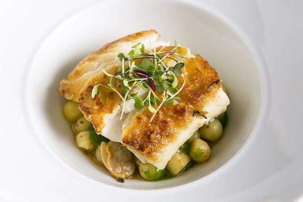 Cod with olive oil poached potatoes, clams, watercress puree, and beurre fondu.(Samira Bouaou/Epoch Times)
