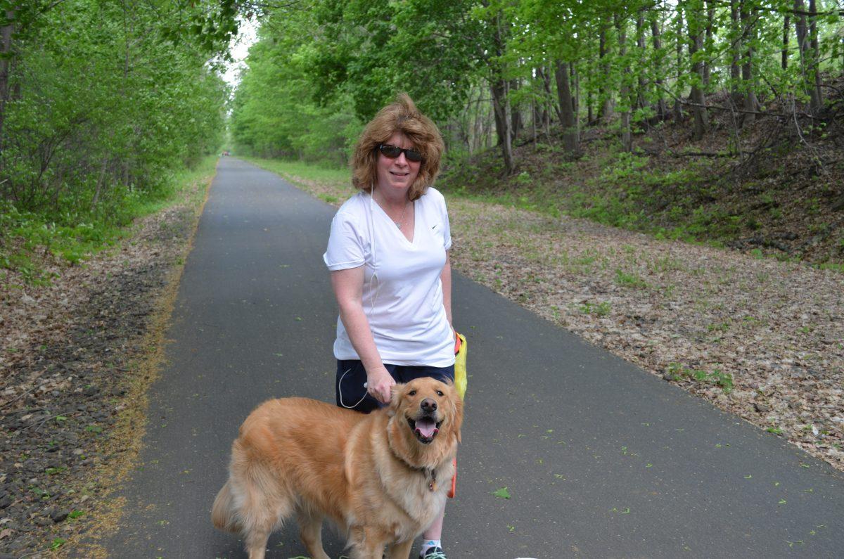 A local resident with her golden retriever on the Goshen section of the Orange County Heritage Trail on May 16, 2015. (Yvonne Marcotte/Epoch Times)