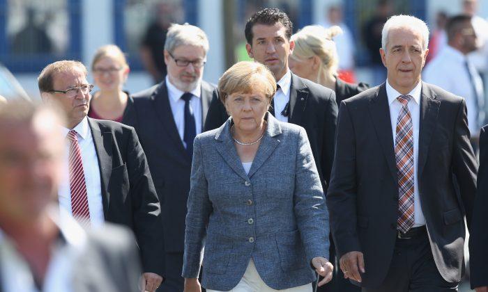 Merkel Travels to Far-Right Heartland to Defend Refugees