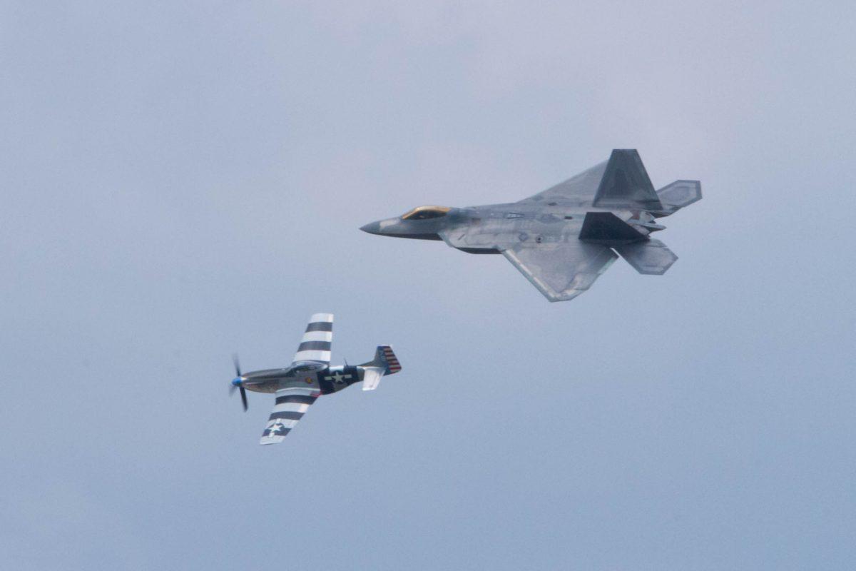 The F-22 Raptor (top) and P-51 Mustang flying in tandem at the York Air Show at Stewart International Airport in New Windsor on Aug. 30, 2015. (Holly Kellum/Epoch Times)