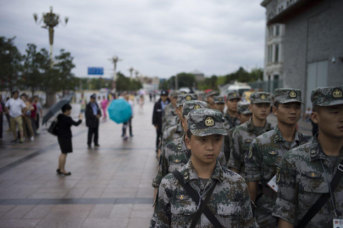 Before a planned military parade, the People’s Liberation Army members stand in Beijing on Sept. 1. The Sept. 3 parade will showcase many weapons systems the Chinese regime plans to sell. (Fred Dufour/AFP/Getty Images)