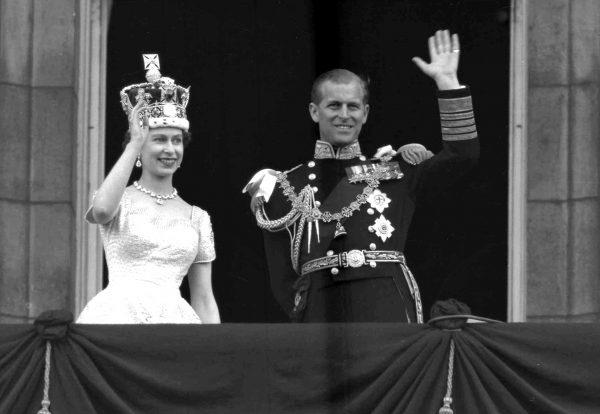 Queen Elizabeth II and Prince Philip, Duke of Edinburgh, wave to supporters from the balcony at Buckingham Palace following her coronation at Westminster Abbey in London on June 2, 1953. (Leslie Priest/AP Photo, File)