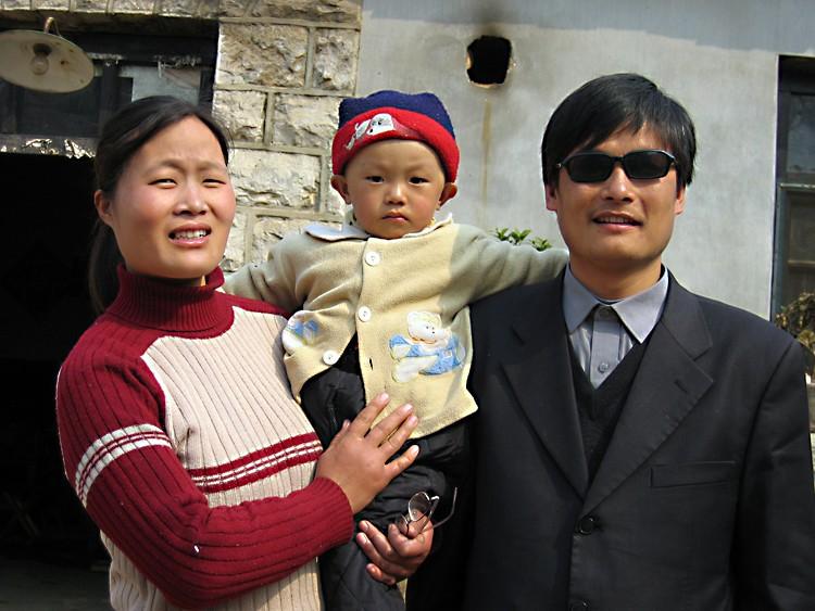 A picture dated March 28, 2005, shows blind activist Chen Guangcheng (R) with his wife and child Chen Kerui outside the home in Dondshigu village, northeast China’s Shandong province. Teng Biao helped serve as counsel for Chen. (STR/AFP/Getty Images)