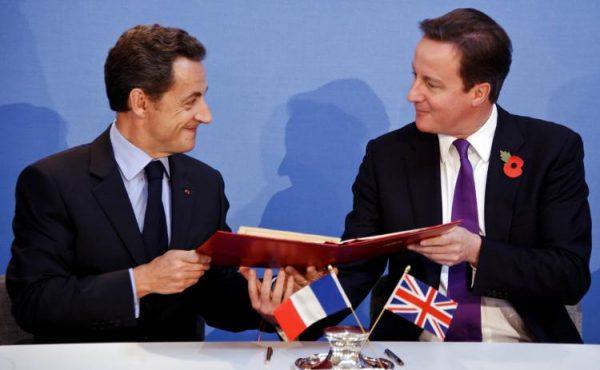 French President Nicolas Sarkozy (L) and Prime Minister David Cameron exchange copies after signing a treaty during the Anglo-French summit at Lancaster House on Nov. 2, 2010 in London, England. (Lionel Bonaventure/Getty Images)