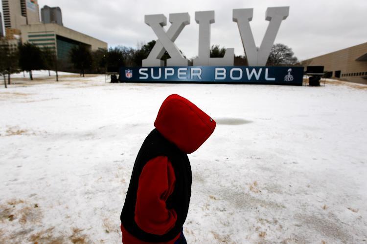 Rolling Blackouts: Robert Garza, 10, walks through snow and ice while visiting an NFL Super Bowl XLV display on Feb. 1 in Dallas. The Electric Reliability Council of Texas imposed rolling blackouts on Feb. 2 to prevent its generators from shutting down. (Tom Pennington/Getty Images)