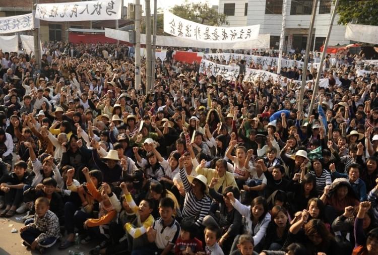 Residents of Wukan, a fishing village in the southern province of Guangdong, rally to demand the government take action over illegal land grabs and the death in custody of a local leader on December 15, 2011. (Peter Parks/AFP/Getty Images)
