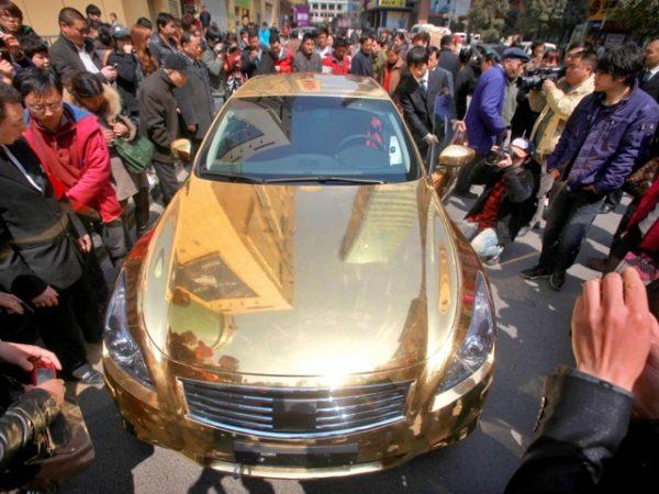 A gold-plated Infiniti luxury sports car outside a jewelry store in Nanjing, in East China’s Jiangsu Province, March 31, 2011. Corrupt officials, who often use their stolen money on extravagant luxury items like this, are a problem for the CCP as such officials plunder wealth and flee the country. (STR/AFP/Getty Images)