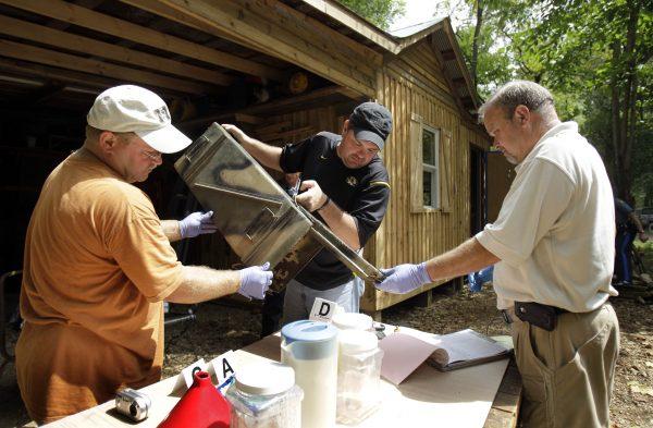 In a file photo, Franklin County authorities sort through evidence during a raid of a suspected meth house in Gerald, Mo., on Sept. 2, 2010. (AP Photo/Jeff Roberson)