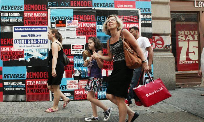 Shoppers and pedestrians walk up Broadway in New York City, on July 16. Retail sales declined for a third straight month as the U.S. economic recovery remains shaky. (Mario Tama/Getty Images)