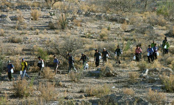 Mexican immigrants walk in line through the Arizona desert near Sasabe, Sonora State, in an attempt to illegally cross the U.S.-Mexico border, on April 6, 2006. (Omar Torres/AFP/Getty Images)