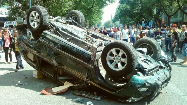 People take pictures of a Japanese car damaged during a protest against Japan's "nationalizing" of the disputed Diaoyu Islands, also known as the Senkaku Islands in Japan, in Xi'an, northwest China's Shaanxi Province, on Sept. 15, 2012. (AFP/GettyImages)