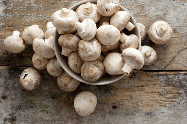 Fresh, whole white button mushrooms, or agaricus (budgetstockphoto/iStock)