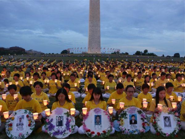Falun Gong practitioners hold candles to honor the thousands who have died in the Chinese regime's persecution of the peaceful meditation practice. Seen from above, they form the shape of the Chinese characters for truthfulness, compassion, and tolerance, the key principles of the practice. (Lisa Fan/The Epoch Times)