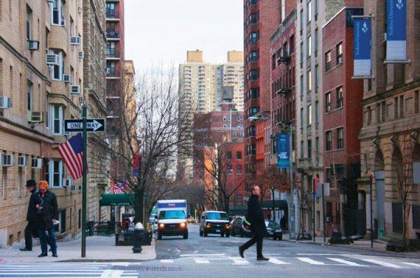 A pedestrian walks across the street on 35th Street in the Murray Hill area of Manhattan. (Benjamin Chasteen/The Epoch Times)