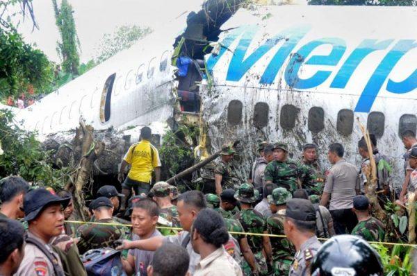 Indonesian soldiers and police examine a Merpati airline 737 plane after it skidded off the runway on landing in Indonesia's West Papua city of Manokwari on April 13, 2010. (STR/AFP/Getty Images)