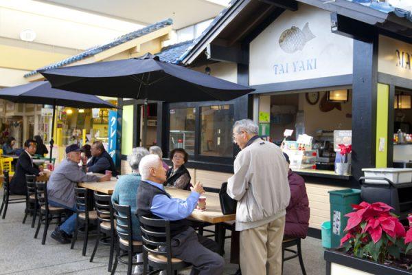 People eat and chat at the Japan Center in San Francisco’s Japantown on Feb. 27. The neighbourhood remains a centre for people of Japanese ancestry to socialise and work in, even if many no longer live there. (Alex Ma/The Epoch Times)