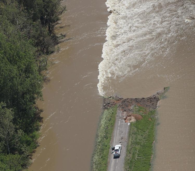 Floodwater flows over the Birds Point Levee after the Army Corps of Engineers blew a massive hole in it to divert water from the town of Cairo, Ill., May 3 near Wyatt, Mo. The Army Corps of Engineers regulates the navigable waters of the United States in conjunction with the EPA.  (Scott Olson/Getty Images)