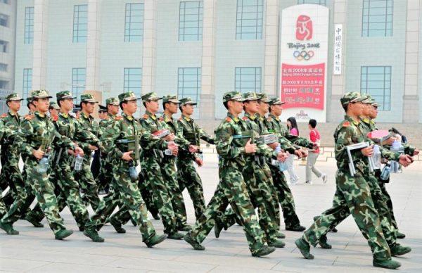 Chinese paramilitary policemen patrol past the Beijing Olympics countdown clock on the edge of Tiananmen Square in Beijing on April 29, 2008. (Teh Eng Koon/AFP/Getty Images)