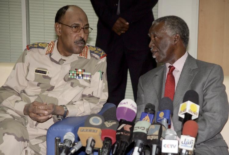 Sudanese Defense Minister Abdel Rahim Mohamed Hussein (L) and chief African Union mediator and former South African president Thabo Mbeki (R) speak prior to their news conference about the release of the United Nations deminers on May 20, 2012. (Ashraf Shazly/AFP/GettyImages)