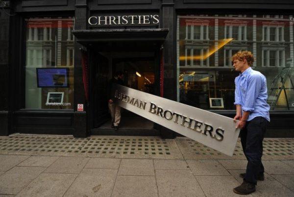 Employees carry a Lehman Brothers sign into Christie's auction house in London. The sign was sold as part of the 'Lehman Brothers: Artwork and Ephemera' sale. (Ben Stansall/AFP/Getty Images)