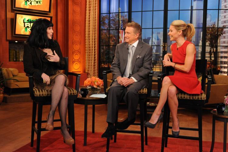 Regis Philbin (C) and Kelly Ripa (R) talk with Cher on "Live! with Regis and Kelly" in a November 2010 file photo. Philbin has announced he is leaving the show after 28 years. (David M. Russell/Disney ABC via Getty Images)